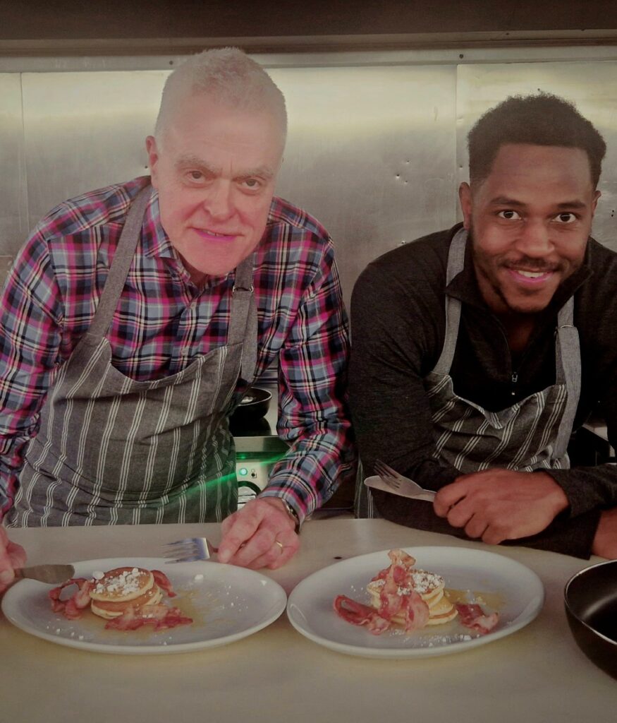 Two men eating pancakes